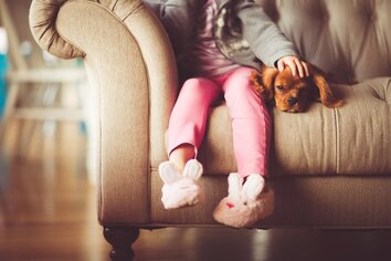 Child on couch with dog- Families Advocating for Chemical & Toxics Safety